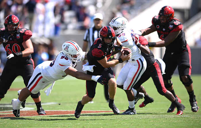 Sep 3, 2022; San Diego, California, USA; San Diego State Aztecs quarterback Braxton Burmeister (5) is tackled by Arizona Wildcats defensive lineman Tiaoalii Savea (98) during the second half at Snapdragon Stadium. Mandatory Credit: Orlando Ramirez-USA TODAY Sports
